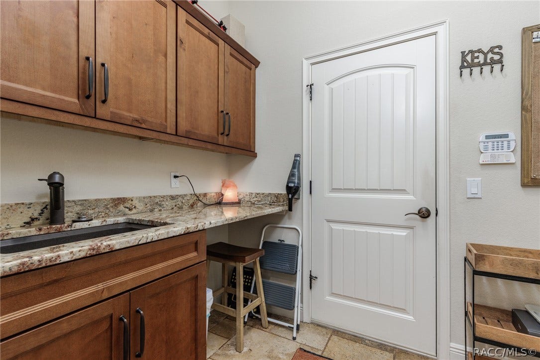 4750 W Mohawk Drive, Beverly Hills, FL 34465 Laundry room with sink & lots of storage
