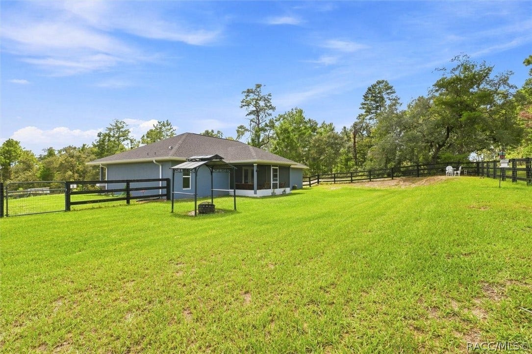 Wire and board fencing and two access gates.  Covered grilling station.