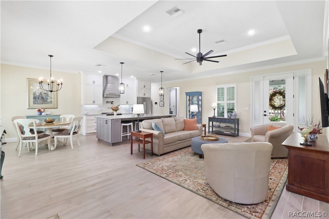 4124 W Pine Ridge Boulevard, Beverly Hills, FL 34465 OPEN-CONCEPT LIVING AT ITS BEST!
Bright & spacious open-concept living area seamlessly connects the GREAT ROOM, dining space & kitchen, creating an inviting layout perfect for everyday living & entertaining. Eye-catching details include a tray ceiling w/ crown molding, recessed lighting & modern oversized ceiling fan, luxury-style porcelain tile flooring & abundant natural light. The kitchen anchors the space w/ a contrasting center island, pendant lighting, white cabinetry & UPGRADED stainless appliances.