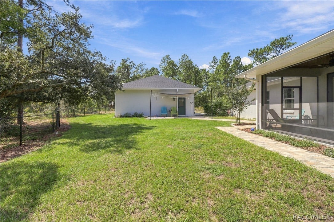 4124 W Pine Ridge Boulevard, Beverly Hills, FL 34465 FENCED BACKYARD + DETACHED GARAGE Spacious backyard provides plenty of room to enjoy the outdoors while the aluminum-style fencing defines the yard without blocking the wooded views. A paver walkway connects the home to the detached garage, creating easy access between both structures.