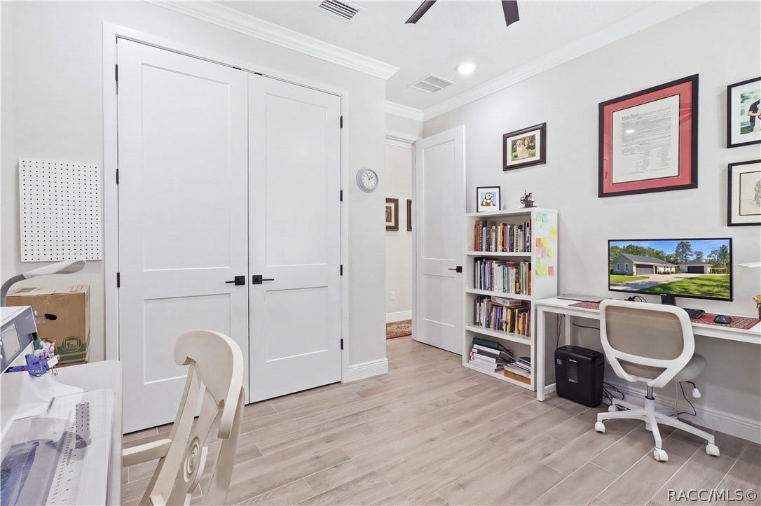 4124 W Pine Ridge Boulevard, Beverly Hills, FL 34465 FLEX ROOM / OFFICE / Bedroom 2 Another angle showcases the room's double-door closet, generous workspace & clean contemporary finishes. This flexible space can easily adapt as an office, craft room, den or additional bedroom depending on your needs.