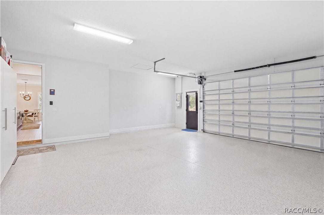 4124 W Pine Ridge Boulevard, Beverly Hills, FL 34465 ATTACHED OVERSIZED GARAGE Clean & spacious attached garage features a finished floor, bright overhead lighting, automatic garage door opener & convenient exterior access door. Direct access into the home makes everyday unloading easy.