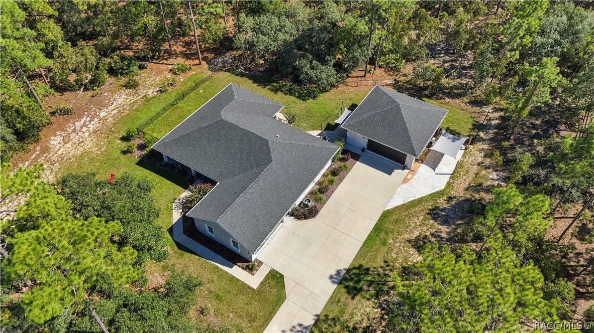 4124 W Pine Ridge Boulevard, Beverly Hills, FL 34465 AERIAL NEIGHBORHOOD VIEW
Elevated aerial perspective showcases the propertys spacious wooded setting & generous setback from the road. Surrounding homes sit on substantial parcels, creating an open residential feel complemented by a mature tree canopy.