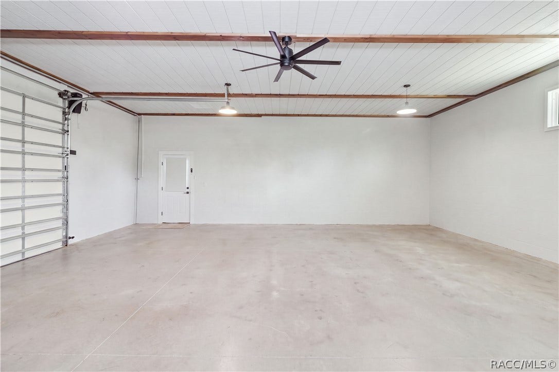 4124 W Pine Ridge Boulevard, Beverly Hills, FL 34465 DETACHED 30x30 GARAGE CLEAN, BRIGHT & FINISHED
An exceptionally clean attached garage featuring a finished epoxy floor, crisp white walls, bright overhead lighting & two windows dressed The wide-open floor space provides plenty of room for parking, storage or a work area or in-law suite