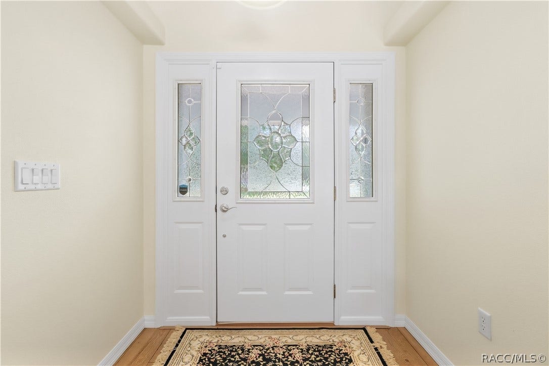2593 S Columbine Avenue, Homosassa, FL 34448 Foyer Bright entry featuring decorative glass front door with matching sidelights and laminate flooring.