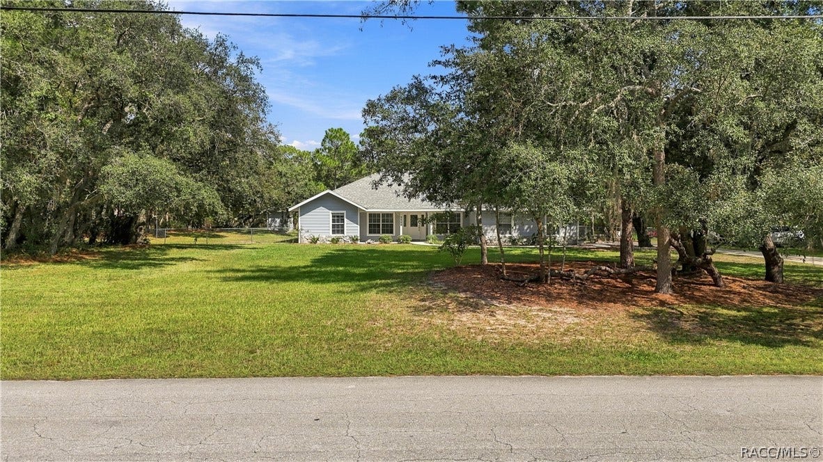 2593 S Columbine Avenue, Homosassa, FL 34448 SPACE & PRIVACY FROM THE STREET Wide front yard with mature trees creating a naturally buffered setting.