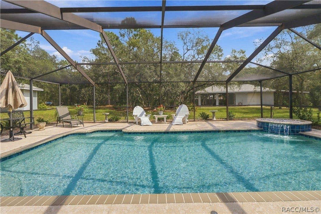 2593 S Columbine Avenue, Homosassa, FL 34448 Screened Pool 14 x24 & Decorative Spillover Waterfall Expansive screened pool area featuring a large salt water swimming pool, waterfall with spillover feature and spacious pool deck.