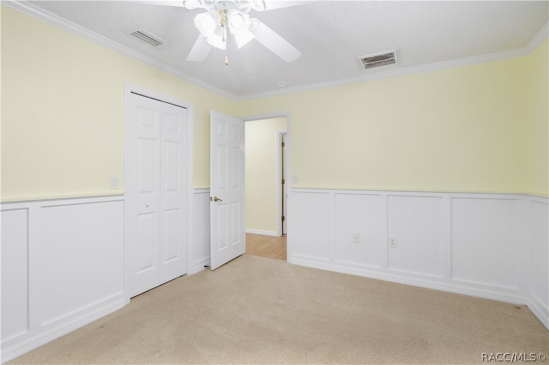 2593 S Columbine Avenue, Homosassa, FL 34448 Additional Guest Bedroom Spacious room with crown molding, ceiling fan, closet and decorative wall molding/wainscoting.