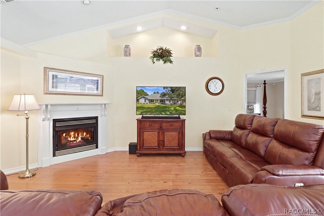 2593 S Columbine Avenue, Homosassa, FL 34448 Living Room with GAS Fireplace Inviting living room featuring a gas fireplace, vaulted ceiling, architectural display ledge, recessed lighting & crown molding. (Gas for the fireplace is not hooked up).