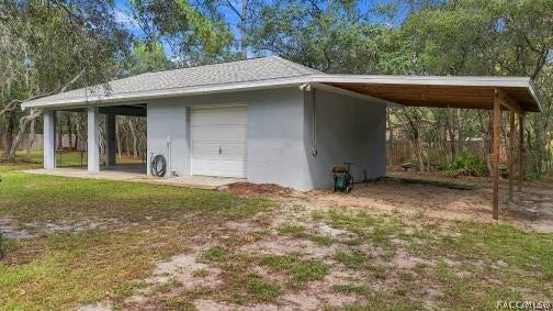 2593 S Columbine Avenue, Homosassa, FL 34448 MORE ROOM FOR THE TOYS Rear view of the detached garage with extended covered parking/storage area.