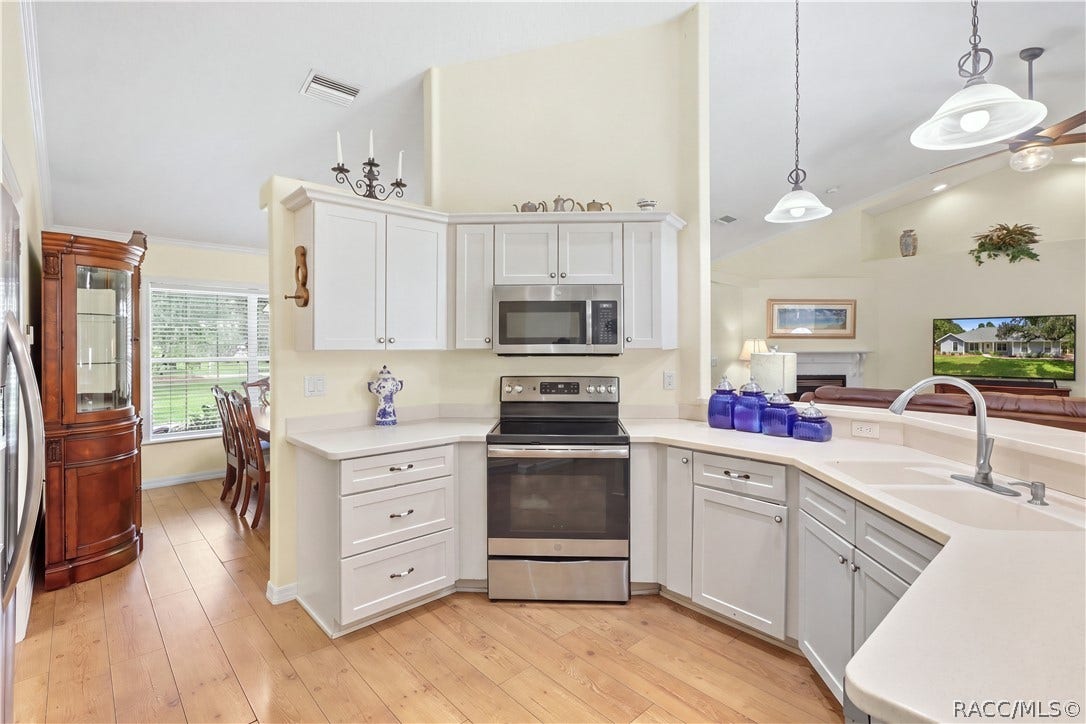 2593 S Columbine Avenue, Homosassa, FL 34448 Kitchen / Open Floor Plan Additional kitchen view showcasing the cabinetry, stainless-steel appliances, breakfast bar & open connection to the living area.
