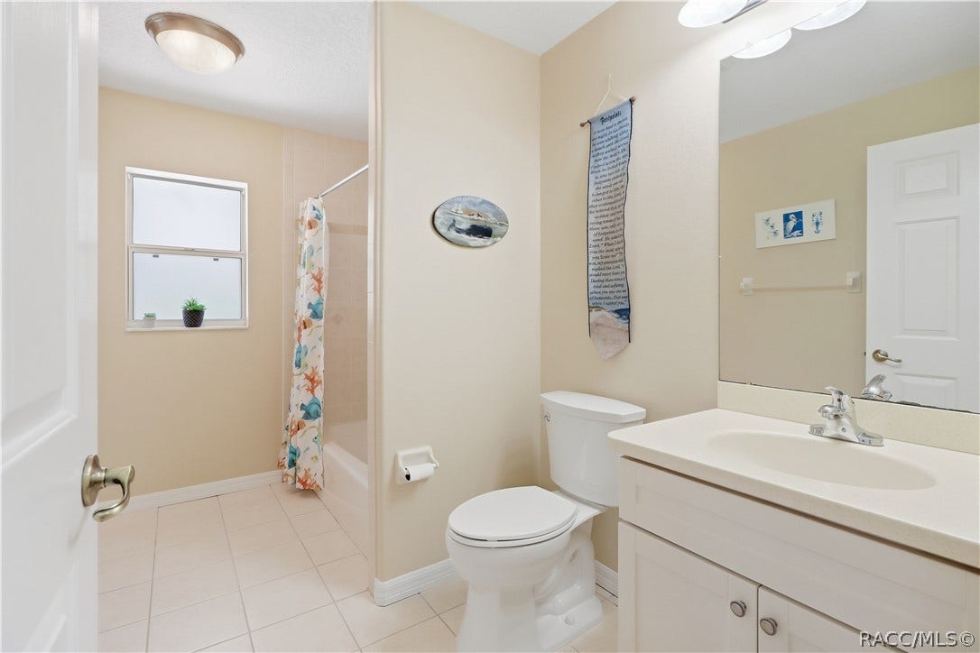 2593 S Columbine Avenue, Homosassa, FL 34448 Guest Bathroom Full guest bath with vanity, tub/shower combination, tile flooring and window for natural light.
