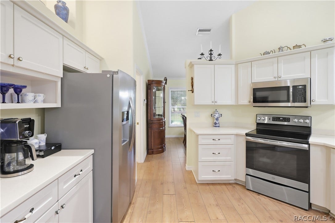 2593 S Columbine Avenue, Homosassa, FL 34448 Kitchen Bright kitchen with abundant white cabinetry, stainless-steel appliances, extensive counter space & laminate flooring.