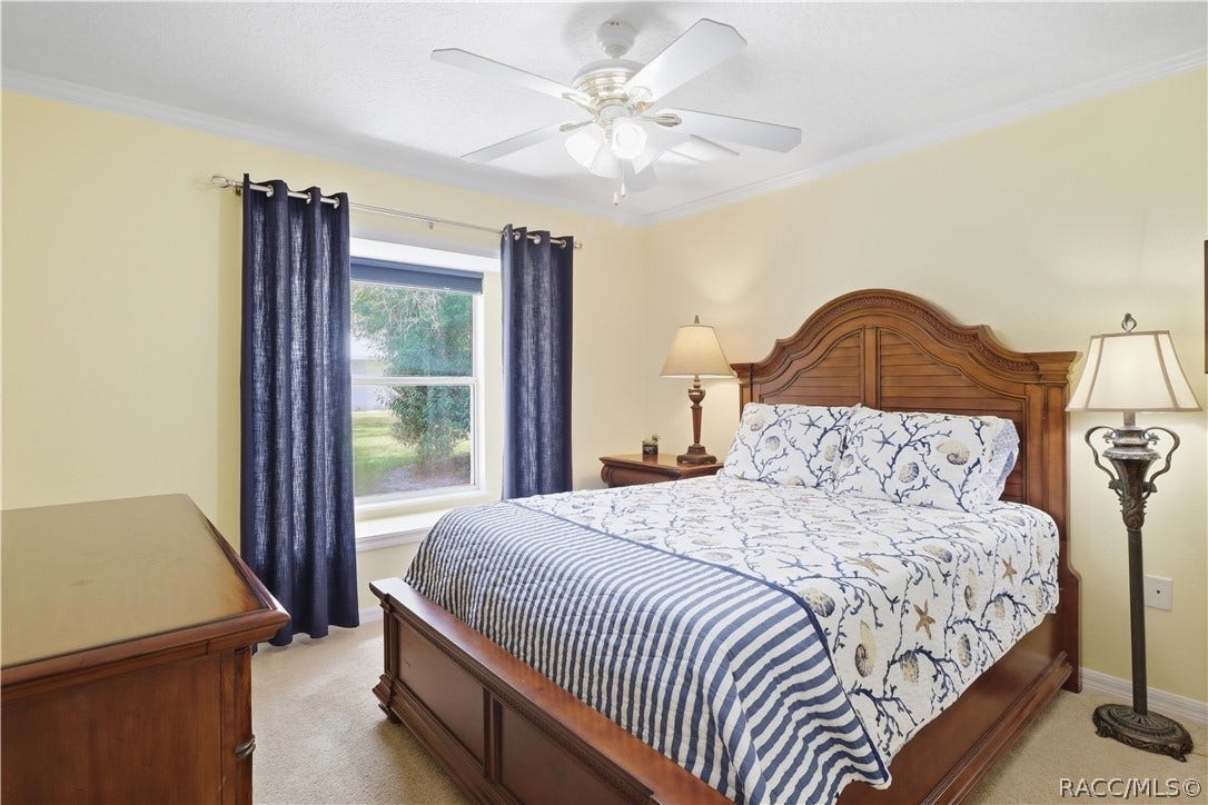 2593 S Columbine Avenue, Homosassa, FL 34448 Guest Bedroom Comfortable guest bedroom with crown molding, ceiling fan and natural light.