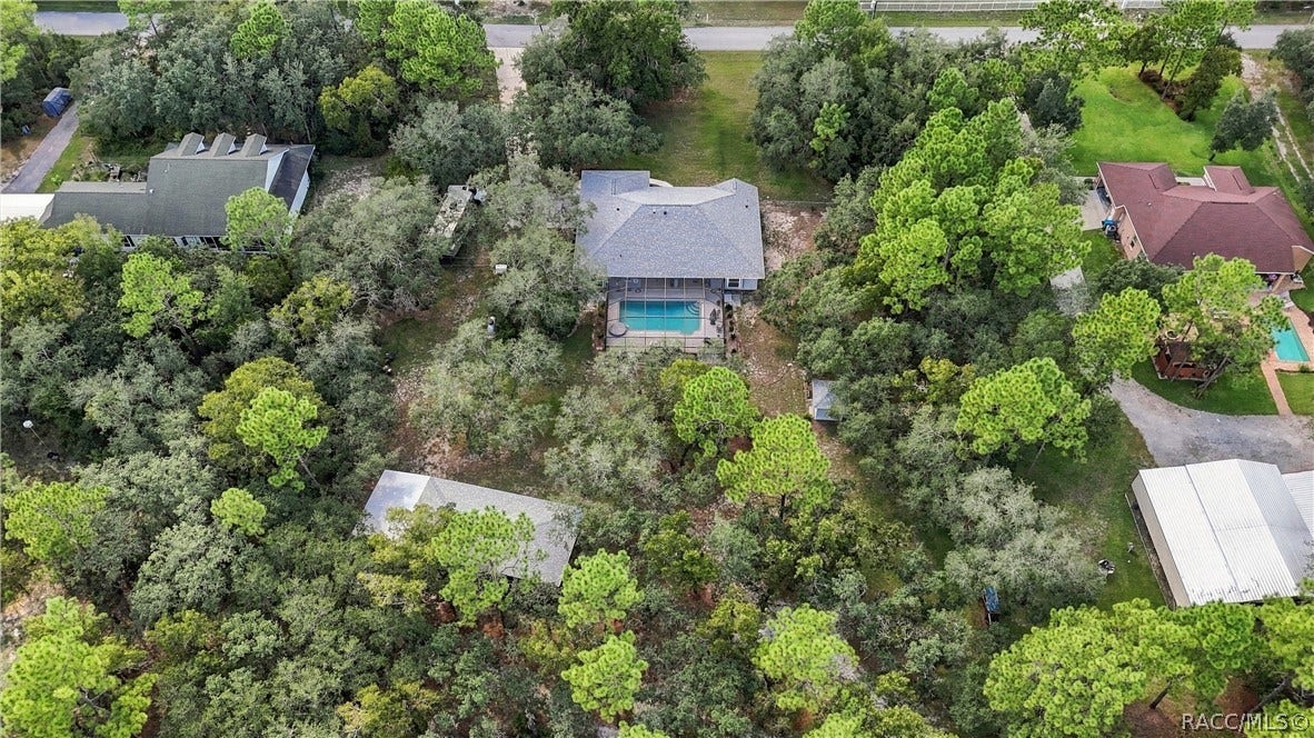 2593 S Columbine Avenue, Homosassa, FL 34448 THE BIG PICTURE Aerial view showcases the home, oversized screened pool, detached garage/outbuilding and expansive property.