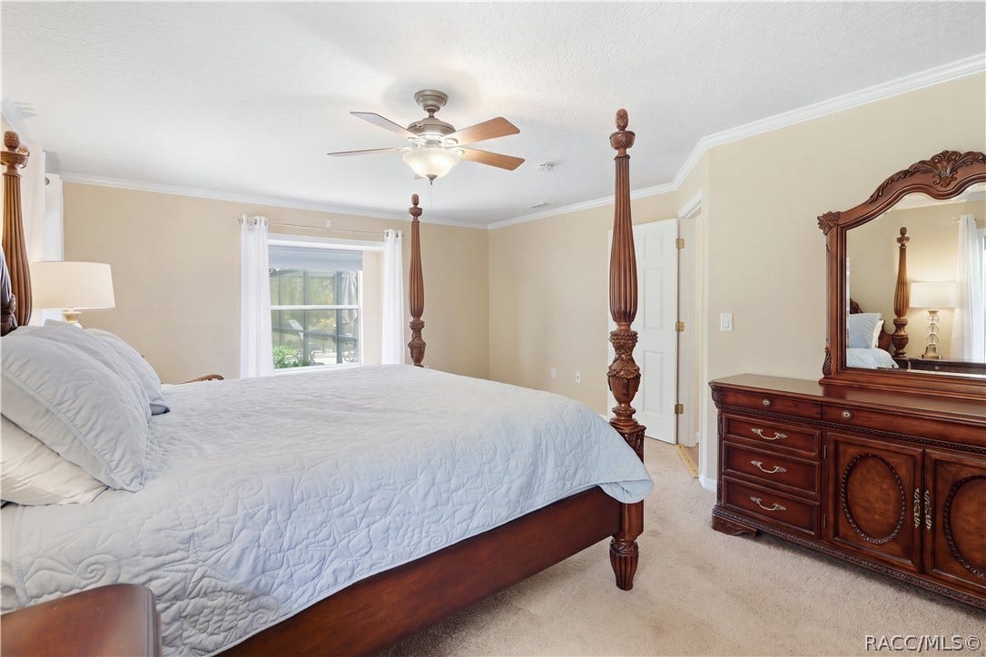 2593 S Columbine Avenue, Homosassa, FL 34448 Primary Bedroom Alternate view highlighting the generous size, natural light and crown molding.