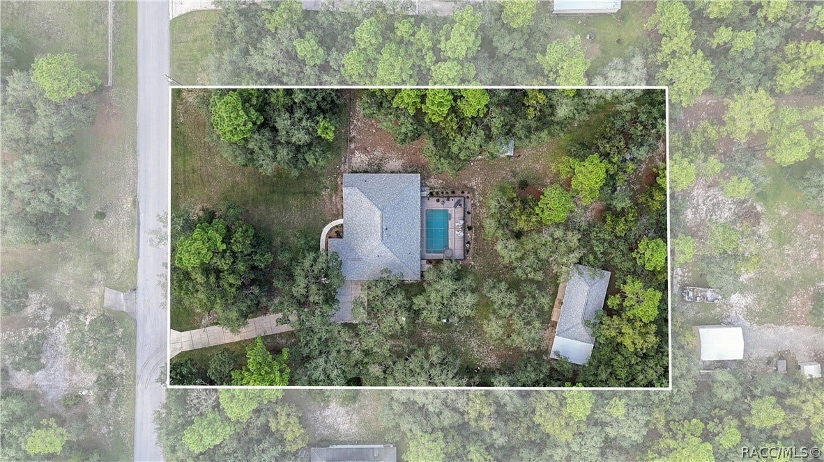 2593 S Columbine Avenue, Homosassa, FL 34448 Aerial View Overhead view showcasing the spacious homesite, residence, screened pool area, detached garage/outbuilding, mature trees & surrounding property.