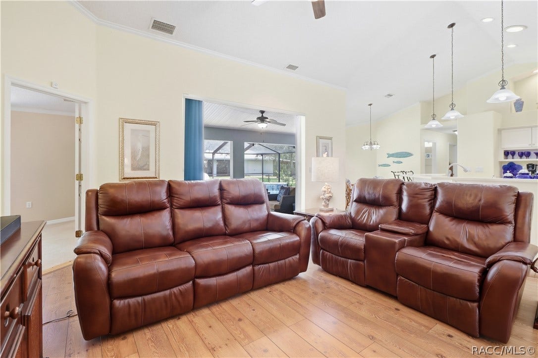 2593 S Columbine Avenue, Homosassa, FL 34448 Open Living Area Spacious living room highlighting the open flow to the kitchen, dining areas & screened pool/lanai.