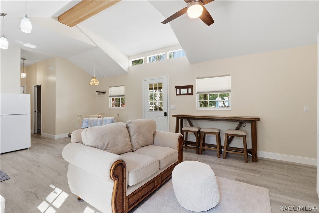 6230 W Glen Robbin Court, Crystal River, FL 34429 Open Floor Plan Natural light fills this cheerful living space featuring VAULTED CEILINGS, decorative wood beam, clerestory windows & a convenient breakfast bar area. An inviting place to relax or gather!