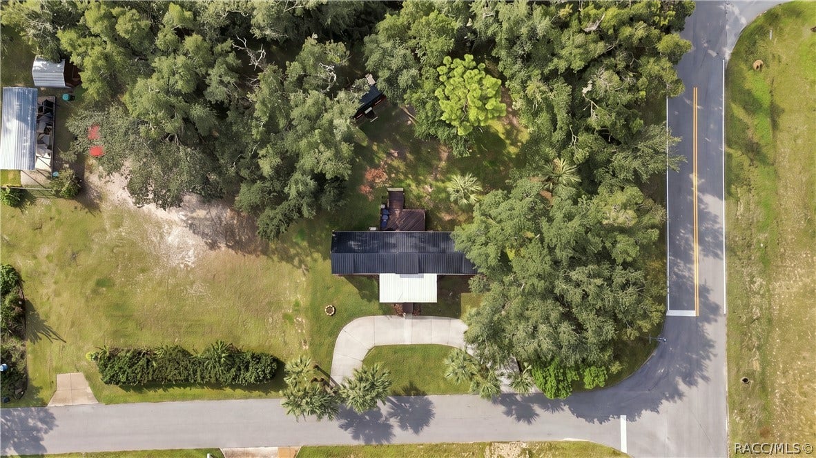 6230 W Glen Robbin Court, Crystal River, FL 34429 Aerial Property View Beautiful overhead perspective showcasing the .29-ACRE CORNER HOMESITE, METAL ROOF, circular concrete driveway, mature shade trees & spacious lawn.