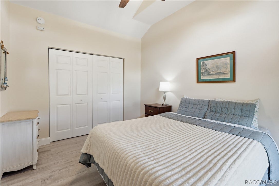 6230 W Glen Robbin Court, Crystal River, FL 34429 Bedroom Comfortable bedroom featuring VAULTED CEILINGS, luxury vinyl plank flooring, ceiling fan, spacious double closets & attractive furnishings.