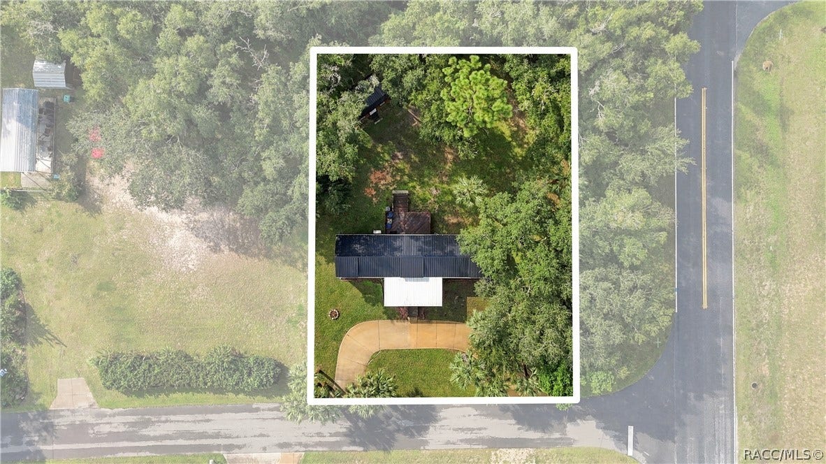 6230 W Glen Robbin Court, Crystal River, FL 34429 Aerial Property View Overhead perspective showcasing the home on its .29-ACRE CORNER LOT, surrounded by mature trees, greenery & a circular driveway.