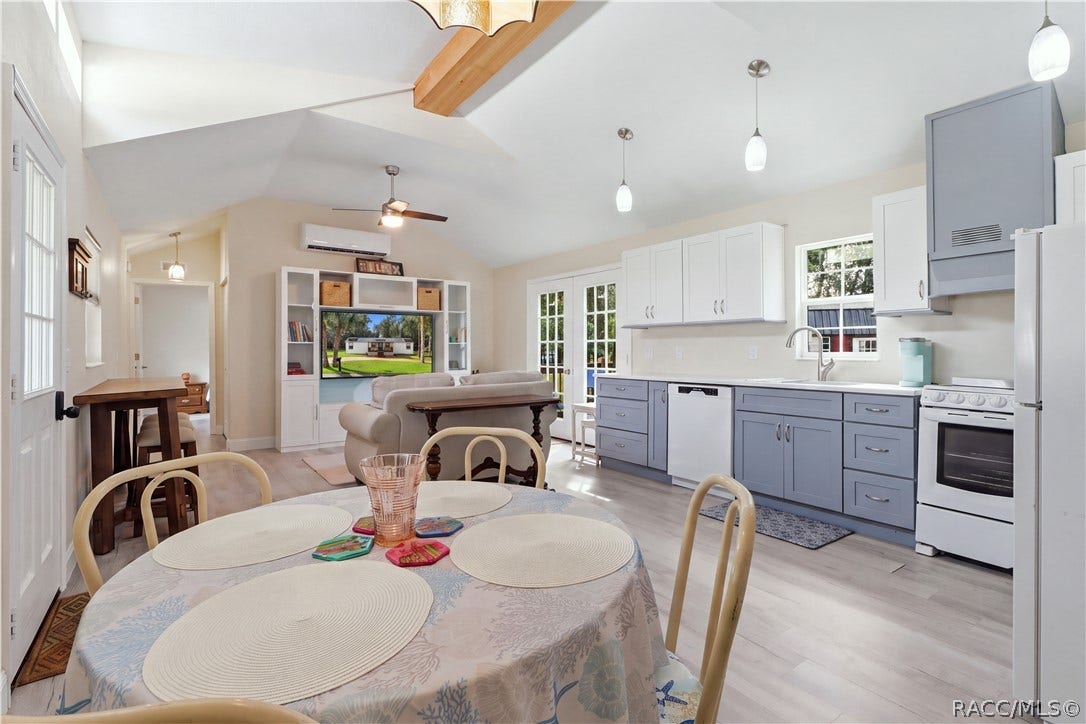 6230 W Glen Robbin Court, Crystal River, FL 34429 Open Living & Kitchen Area Light-filled OPEN FLOOR PLAN featuring VAULTED CEILINGS, attractive flooring, pendant lighting & a beautifully coordinated kitchen.