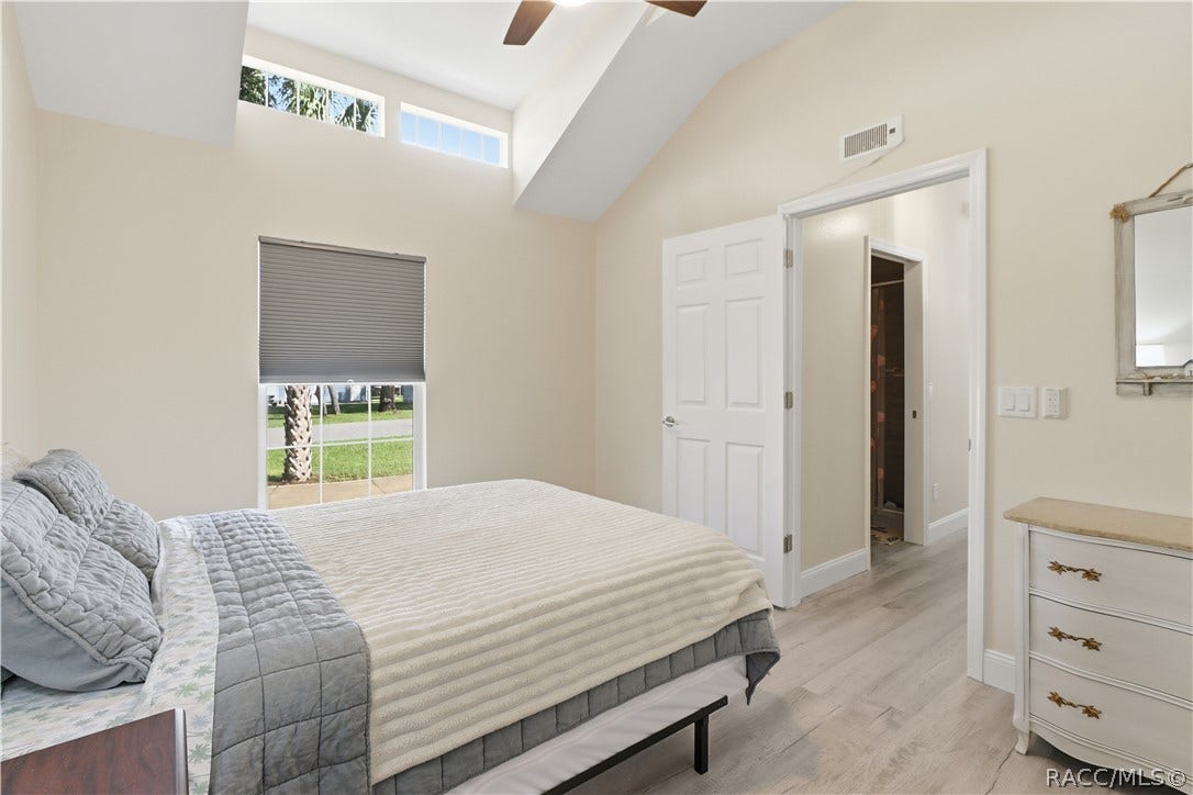 6230 W Glen Robbin Court, Crystal River, FL 34429 Bedroom Comfortable bedroom featuring VAULTED CEILINGS, luxury vinyl plank flooring, ceiling fan, spacious double closets & attractive furnishings.