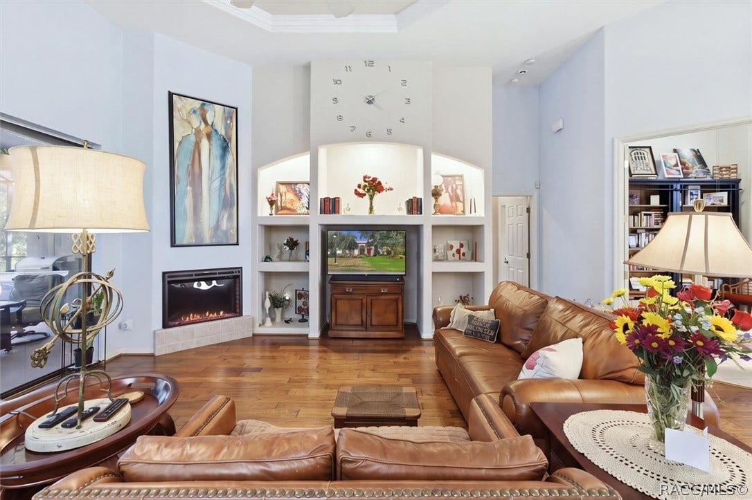 Living area has pool views and fireplace