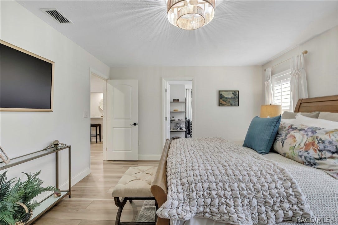 11806 W Riverhaven Drive, Homosassa, FL 34448 Primary bedroom with wood bed frame and dresser.
