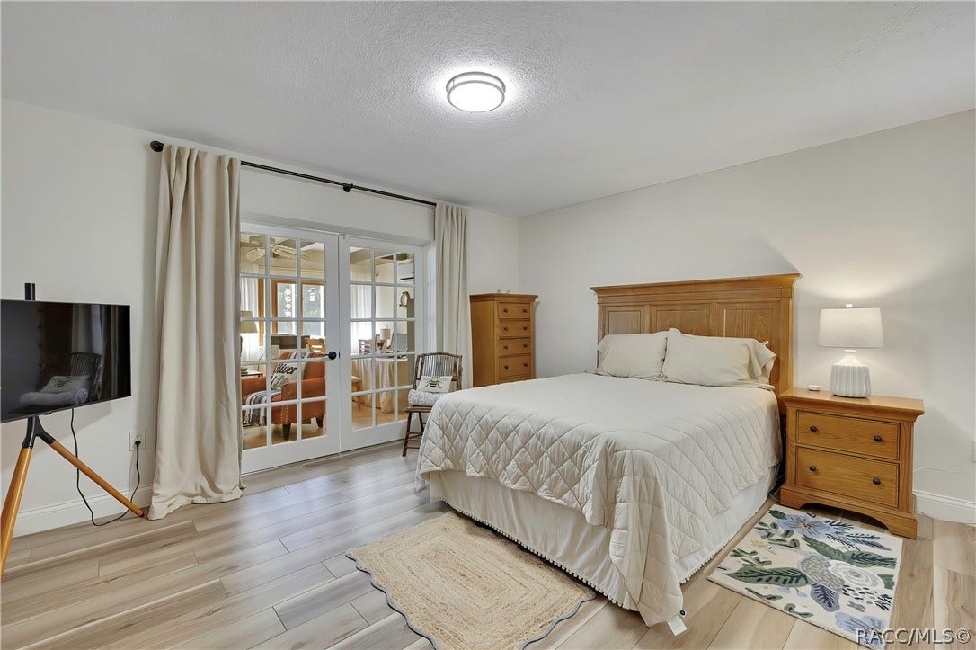 11806 W Riverhaven Drive, Homosassa, FL 34448 Bedroom with sliding glass doors.