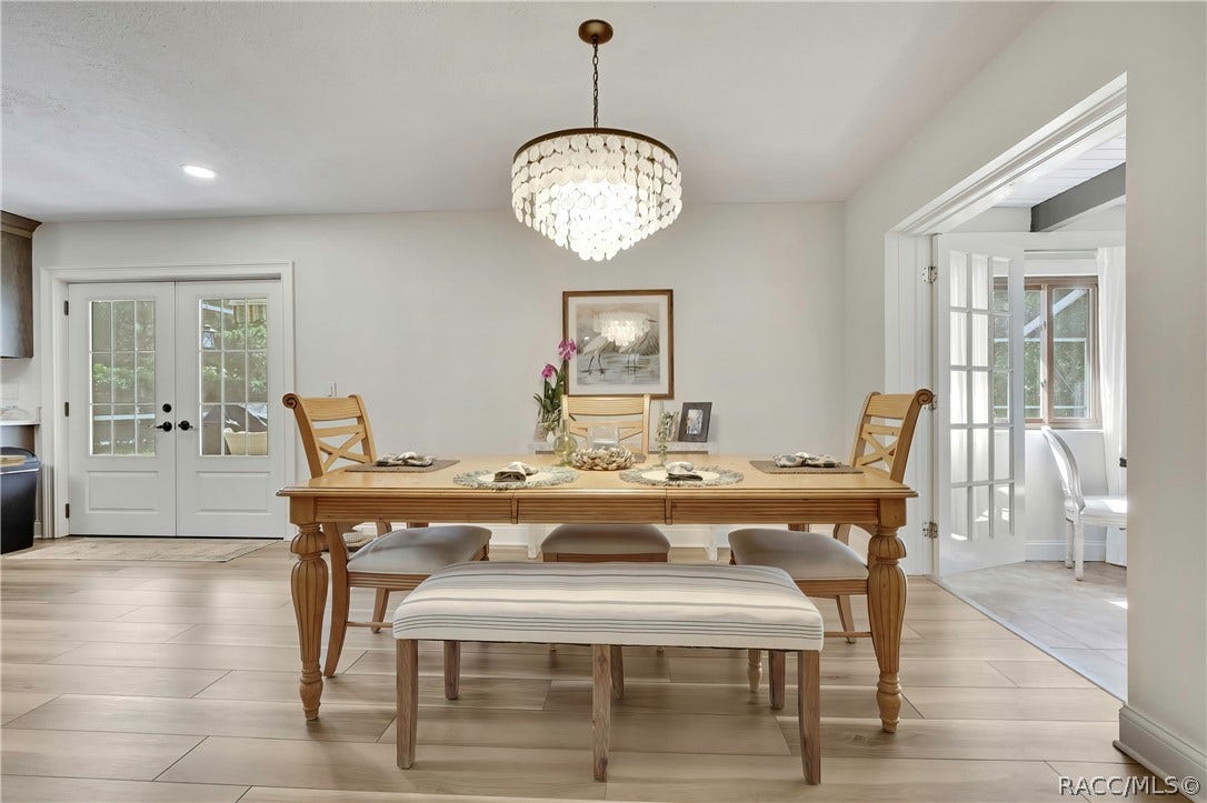 11806 W Riverhaven Drive, Homosassa, FL 34448 Dining area with pendant light and bench seating.