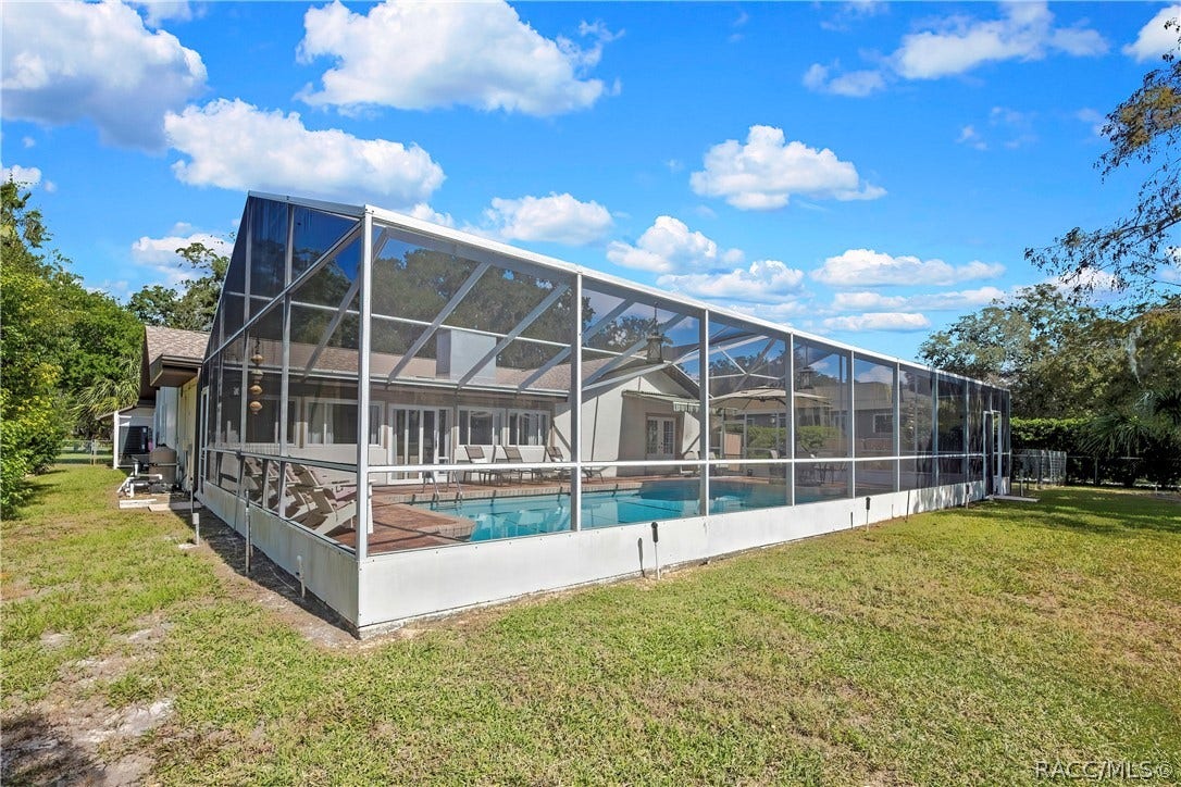 11806 W Riverhaven Drive, Homosassa, FL 34448 Screen pool enclosure viewed from the backyard.