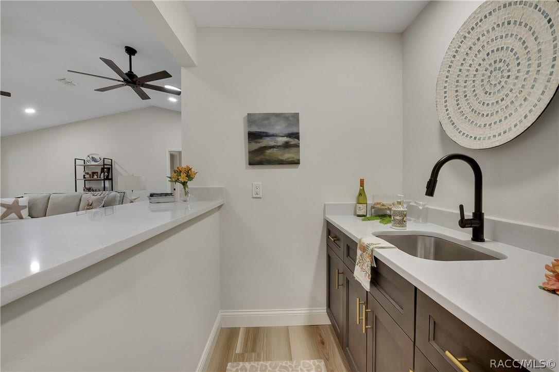 11806 W Riverhaven Drive, Homosassa, FL 34448 Wet bar with sink and cabinet storage off the living area.