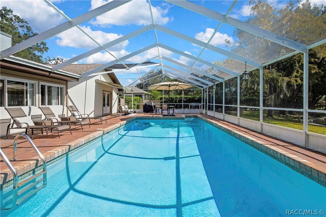 11806 W Riverhaven Drive, Homosassa, FL 34448 Full-length view of the screen-enclosed pool.