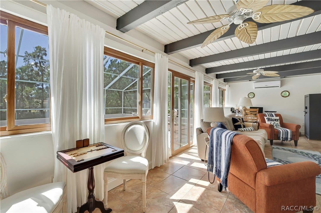 11806 W Riverhaven Drive, Homosassa, FL 34448 Second living area with beamed ceilings and French doors.