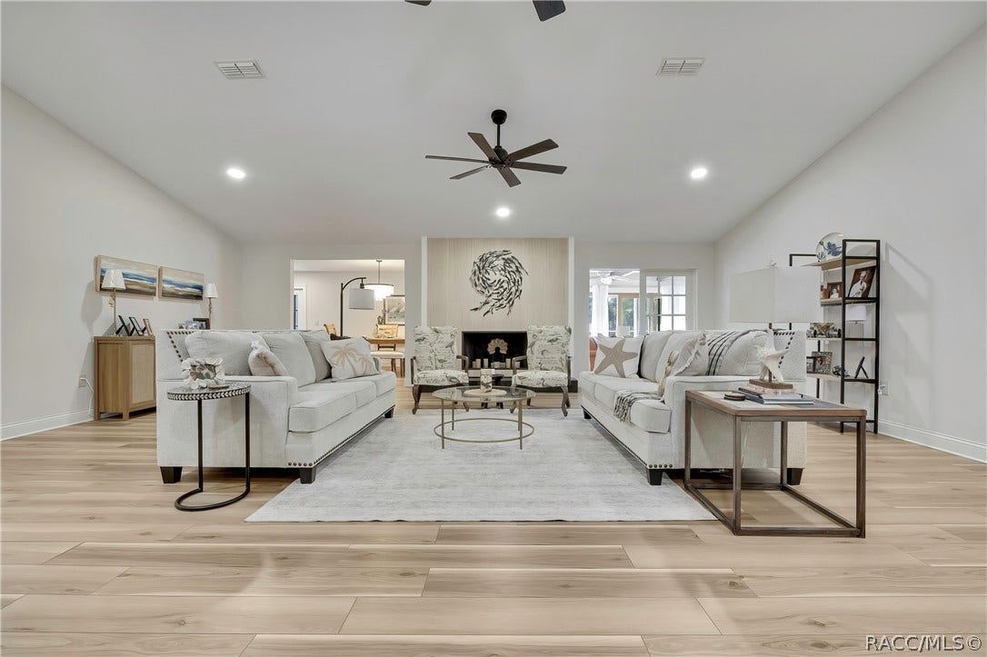 11806 W Riverhaven Drive, Homosassa, FL 34448 Main living area with vaulted ceiling and wood-look floors.