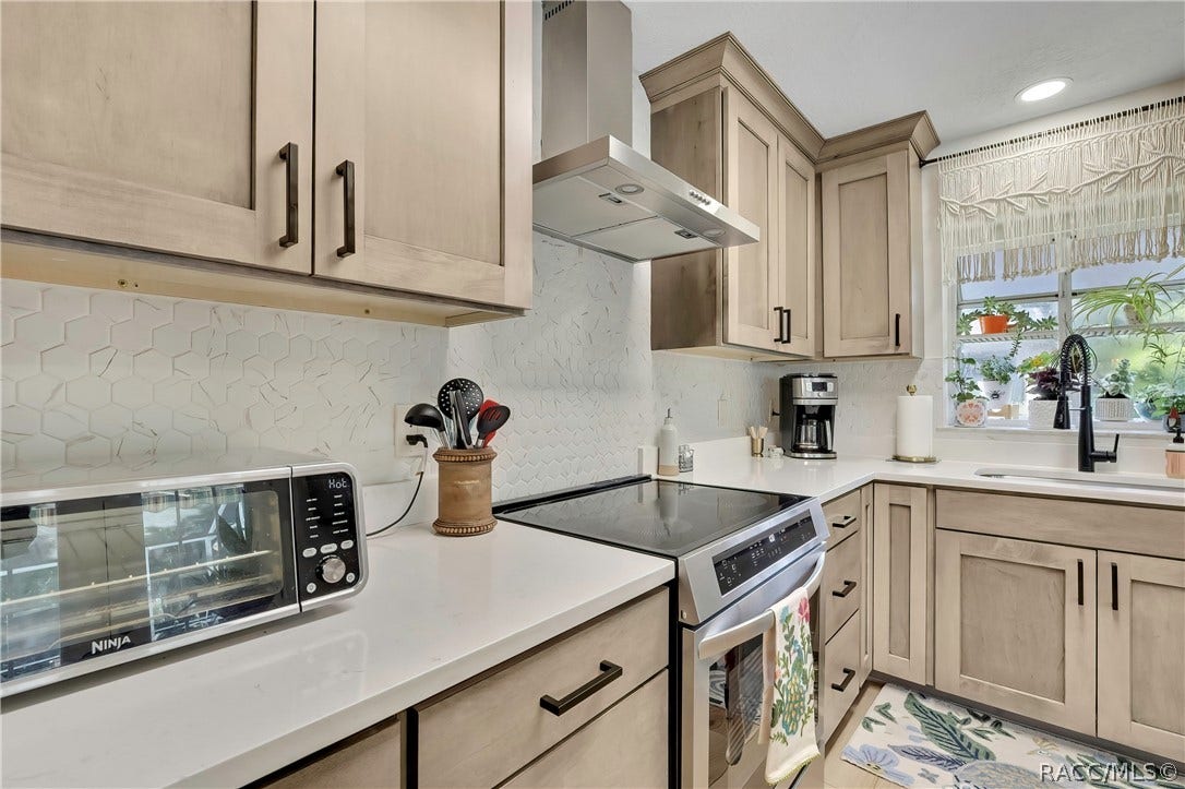 11806 W Riverhaven Drive, Homosassa, FL 34448 Cooking area with electric range and counter space.