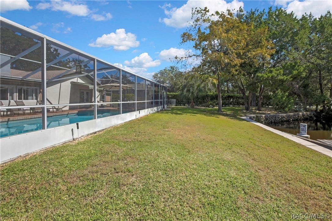 11806 W Riverhaven Drive, Homosassa, FL 34448 Side yard along the pool enclosure.