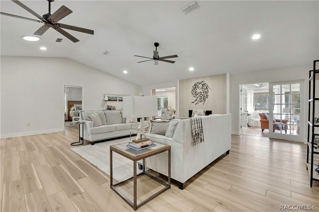 11806 W Riverhaven Drive, Homosassa, FL 34448 Living area with ceiling fan and sliding doors.