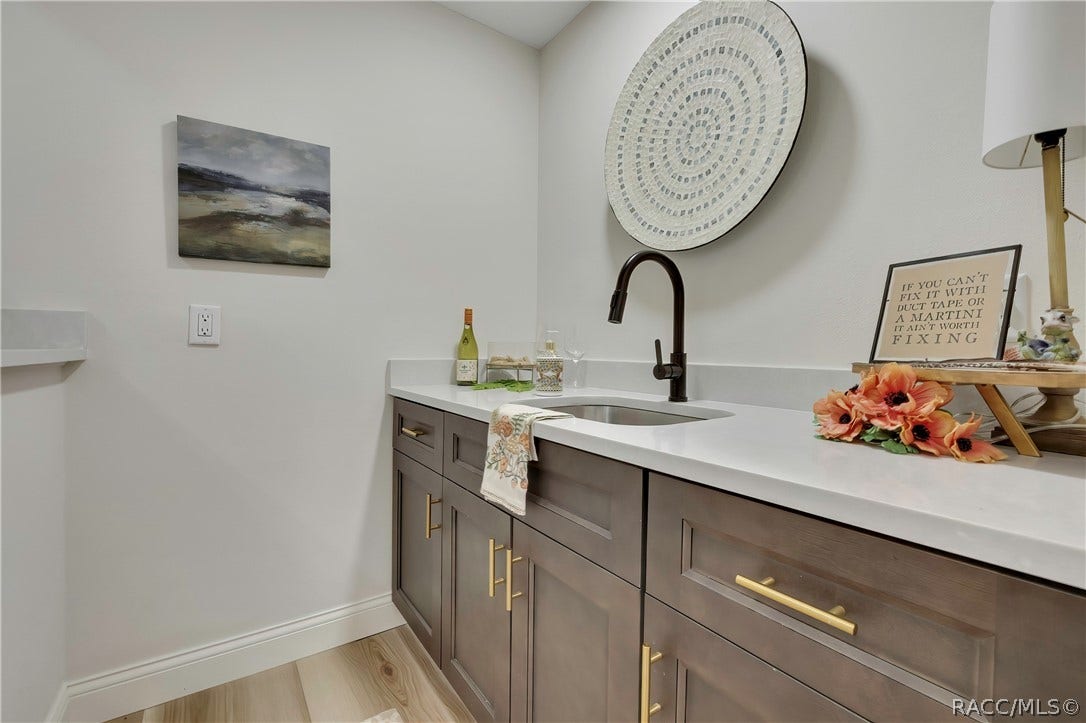 11806 W Riverhaven Drive, Homosassa, FL 34448 Wet bar with sink and cabinet storage off the living area.