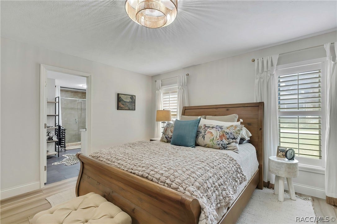 11806 W Riverhaven Drive, Homosassa, FL 34448 Primary bedroom with wood bed frame and dresser.