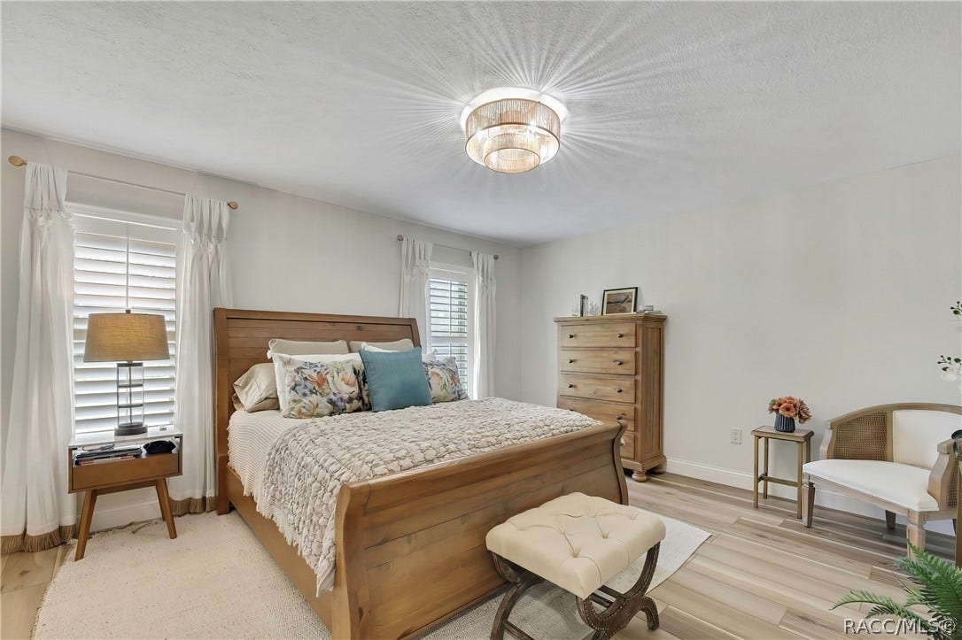 11806 W Riverhaven Drive, Homosassa, FL 34448 Primary bedroom with wood bed frame and dresser.