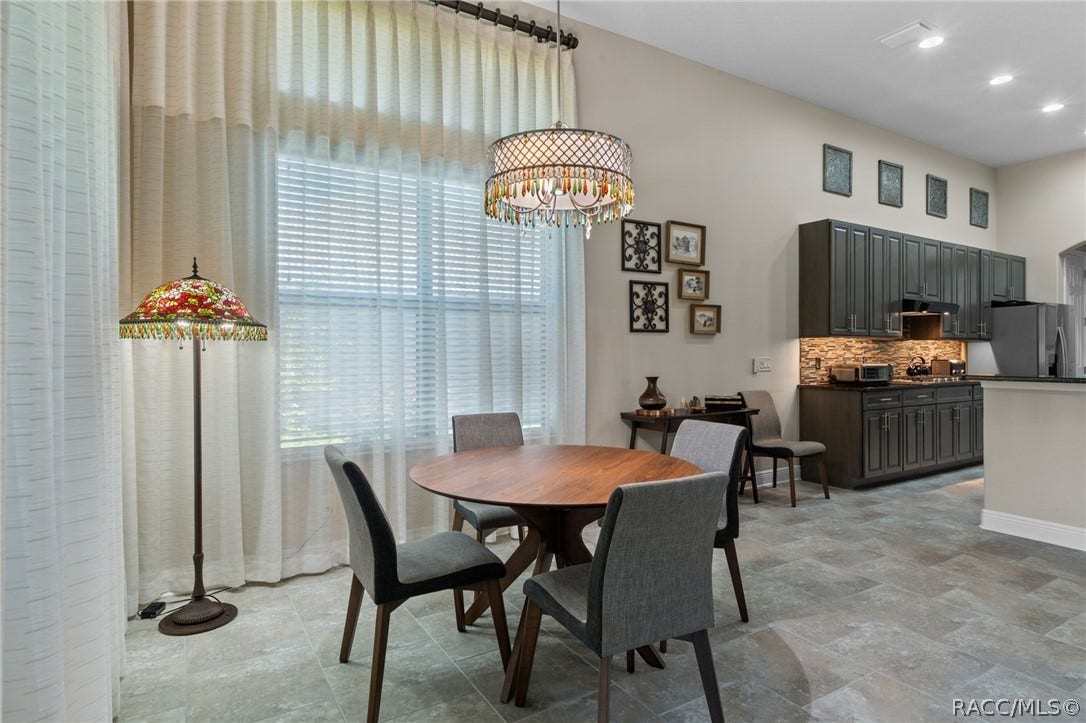 A closer look at the dining section of the great room and the opening to the kitchen.