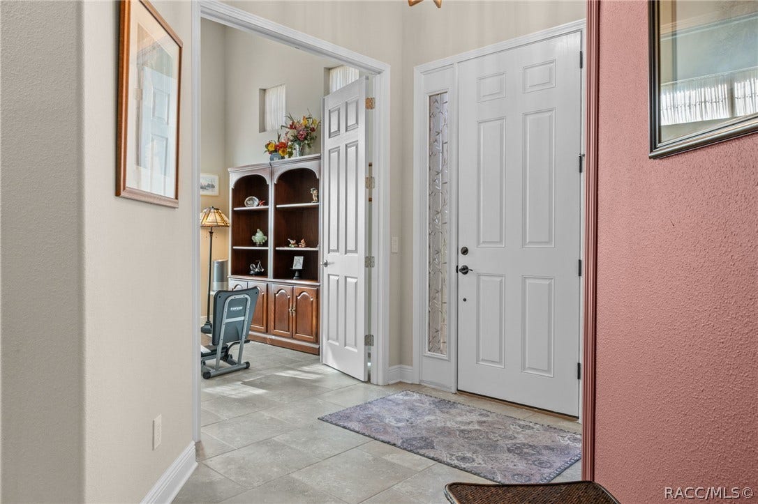 Stepping into the great room and looking back toward the entry door. The flex room, which could be a third bedroom is located right off of the foyer.
