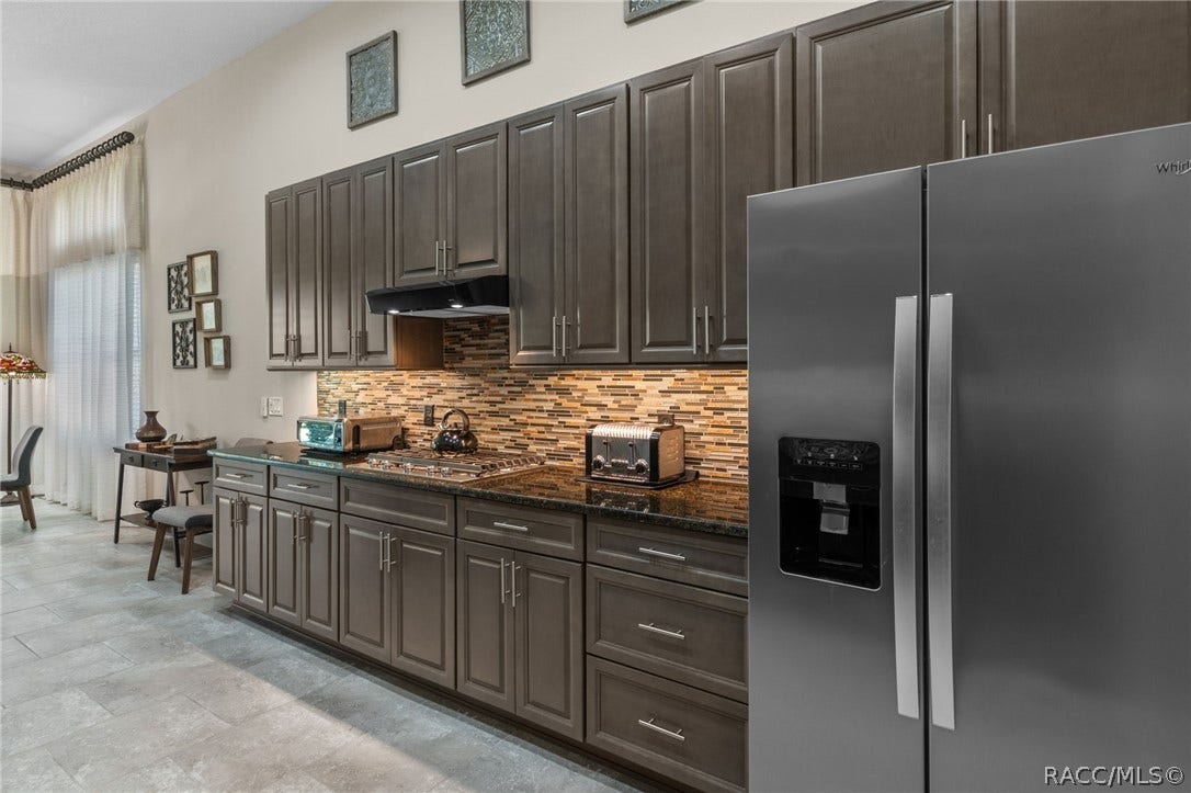 Opposite side of kitchen with more storage and workspace.