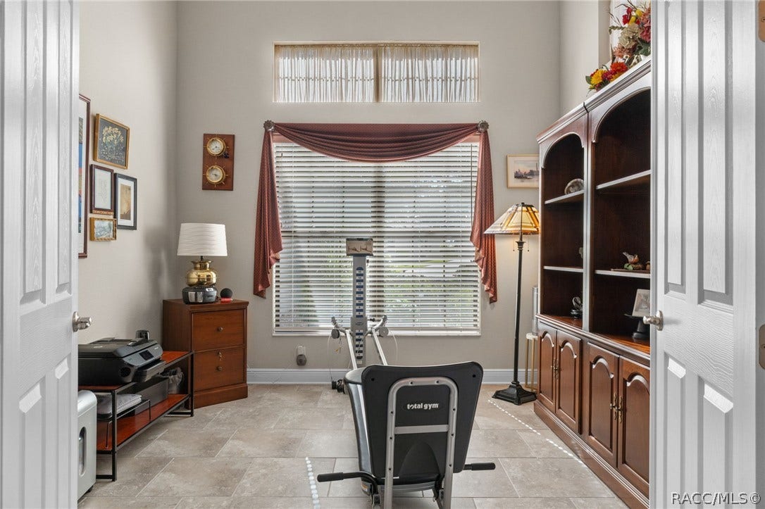 The flex/bonus room is currently used as a gym/den and features double solid French doors for privacy.