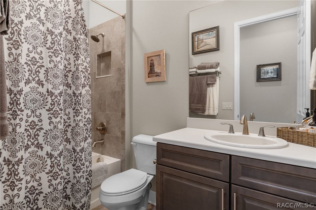 The well appointed guest bath features an upgraded double vanity and other tasteful features.