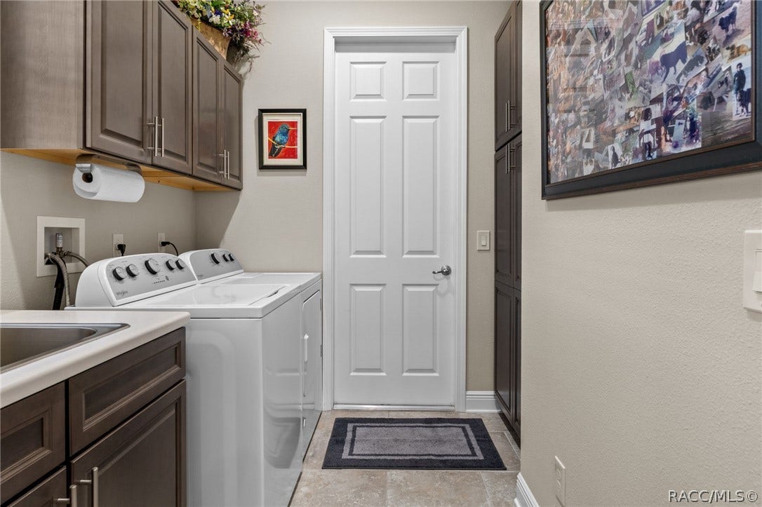 The inside laundry room is separated by a pocket door from the kitchen. The door in this picture leads into the garage. You'll appreciate the additional built-in storage on both sides of the laundry room, and the deep utility sink.