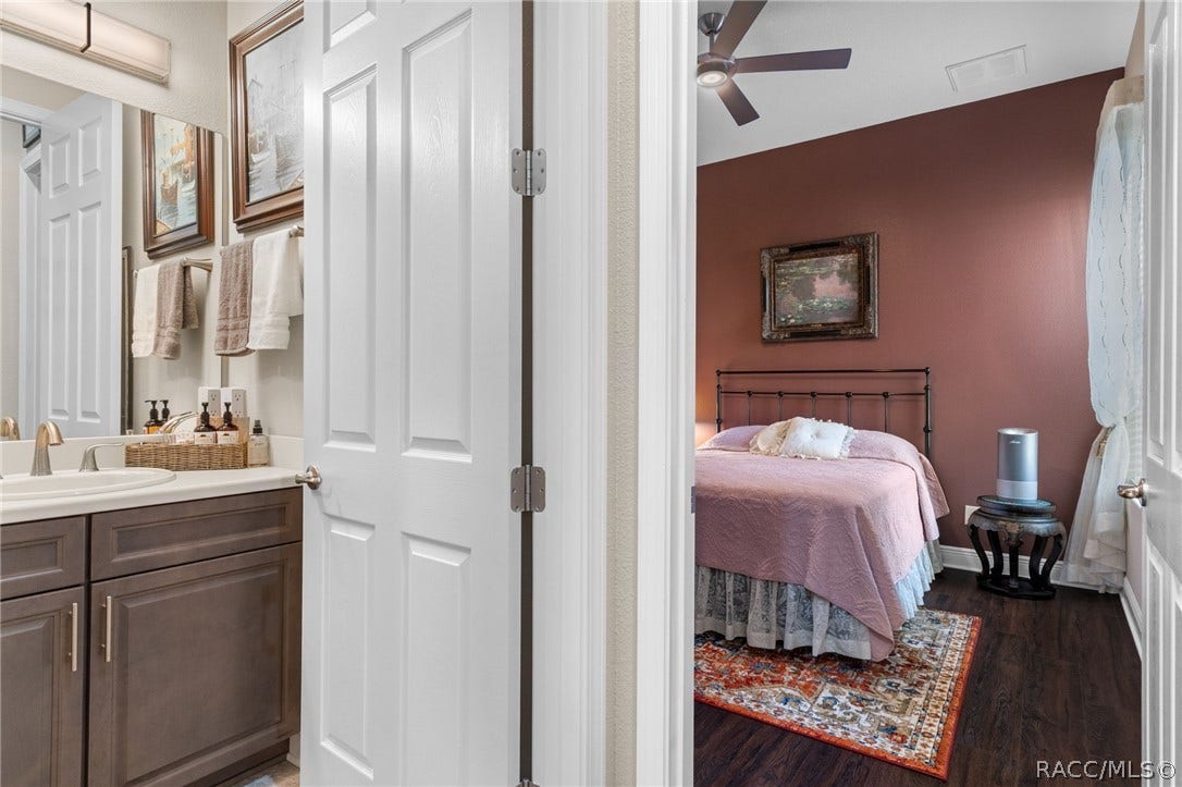 The same color theme is carried through the home in both the bathroom cabinetry, paint colors, and LVP flooring.